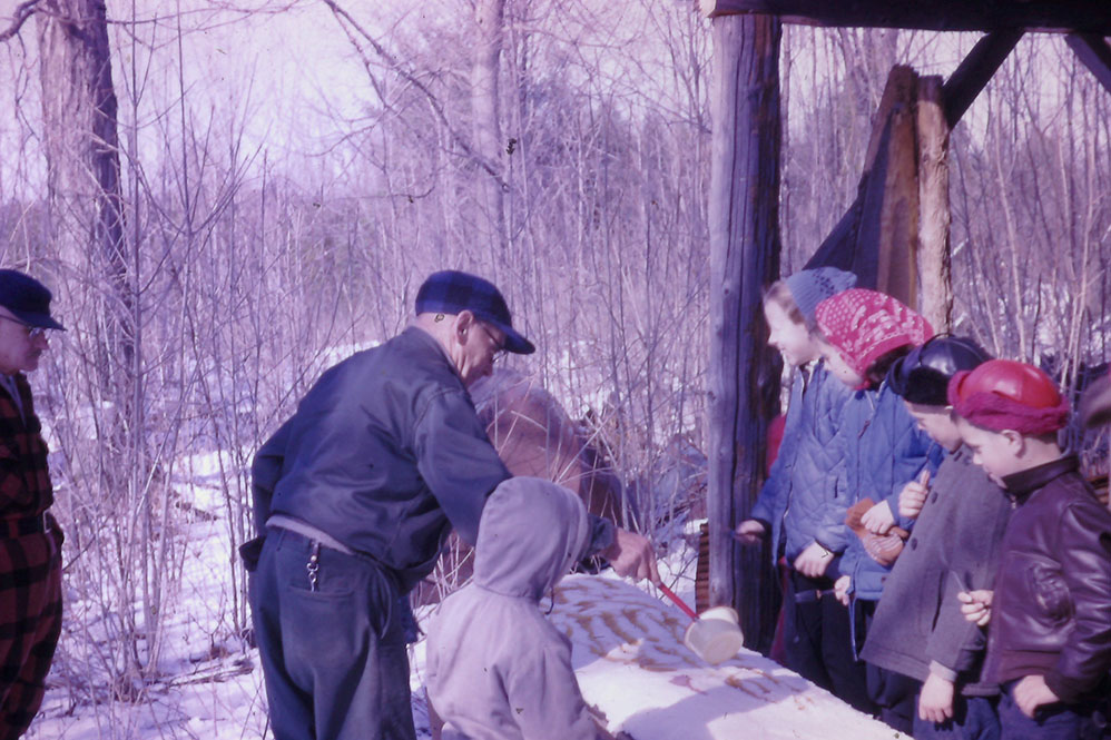 The family enjoying sugar on snow.